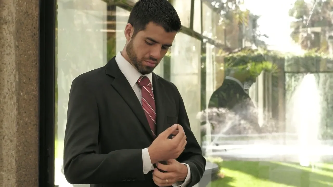 Illustrative groom adjusting his cuff before a wedding